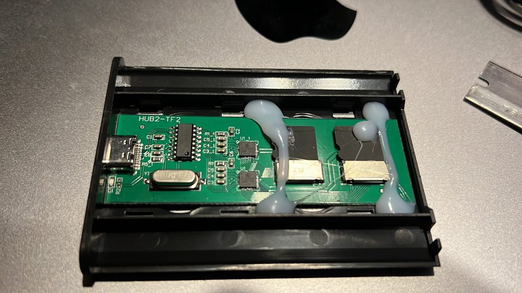 Exposing how the fake ssd is made, with it cut open showing the poor glue job