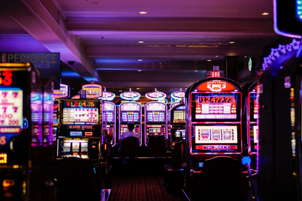 rows of slot machines in Vegas lit up