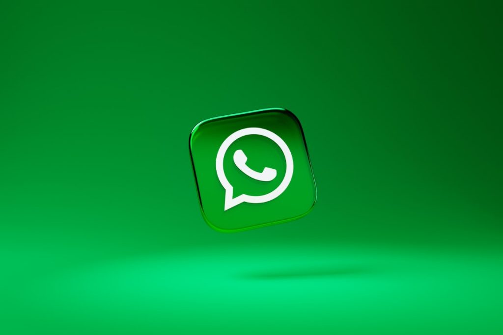 whatsapp icon floating on against a green backdrop