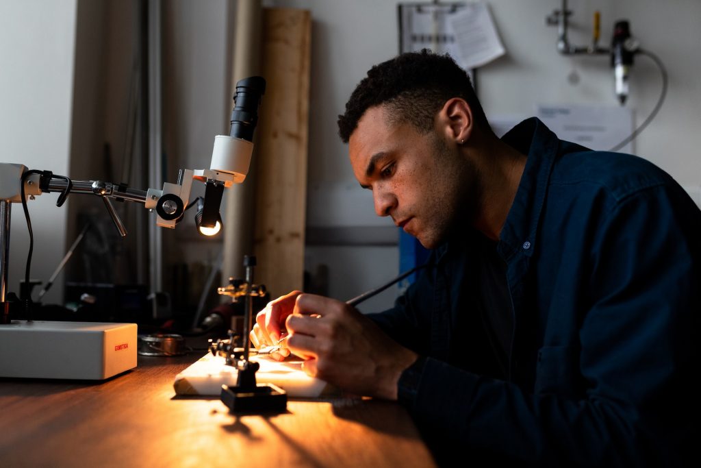 a person soldering on a table