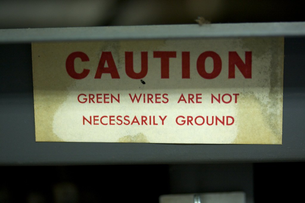 warning sign about a ground wire