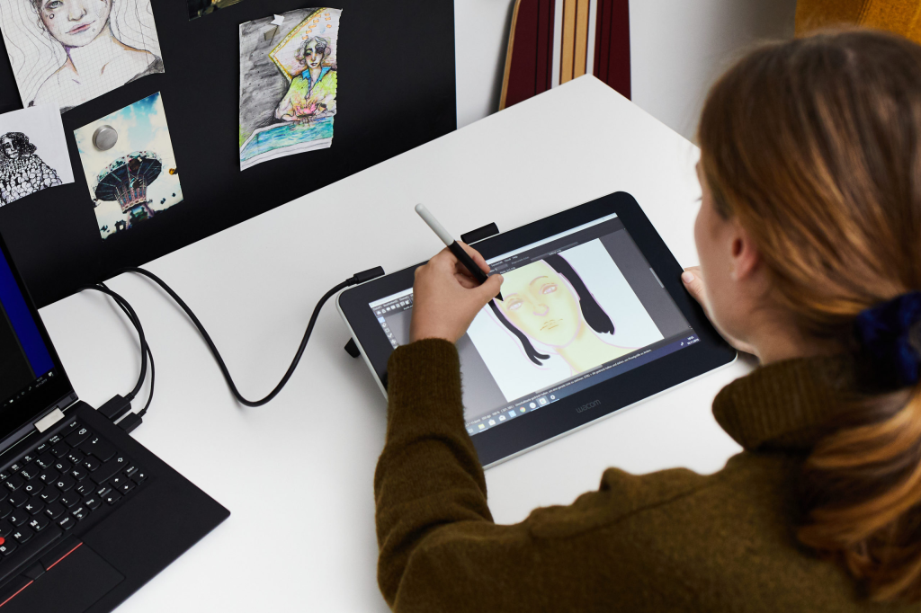a person sketching on a tablet