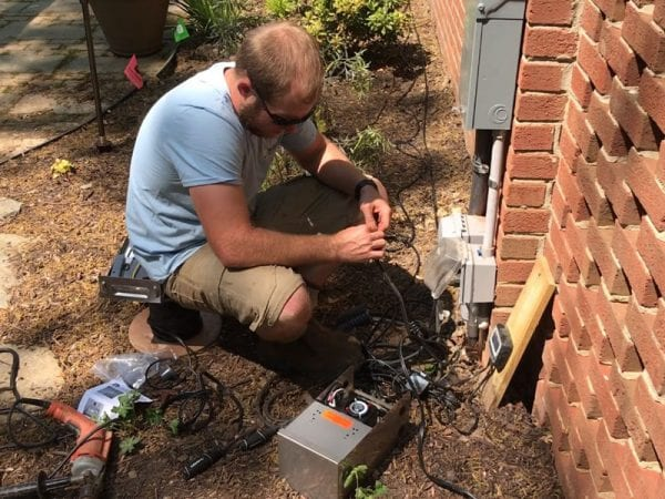 a person Replacing and installing landscape lights